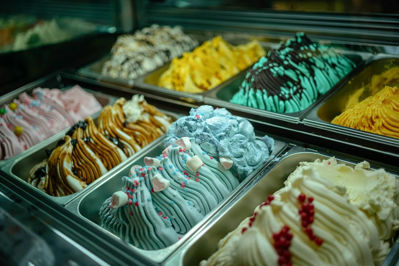 Colorful trays of artisanal gelato flavors at a dessert shop in Trastevere, Rome.